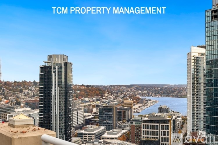 A cityscape with the text "TCM PROPERTY MANAGEMENT" overlaid on the top.