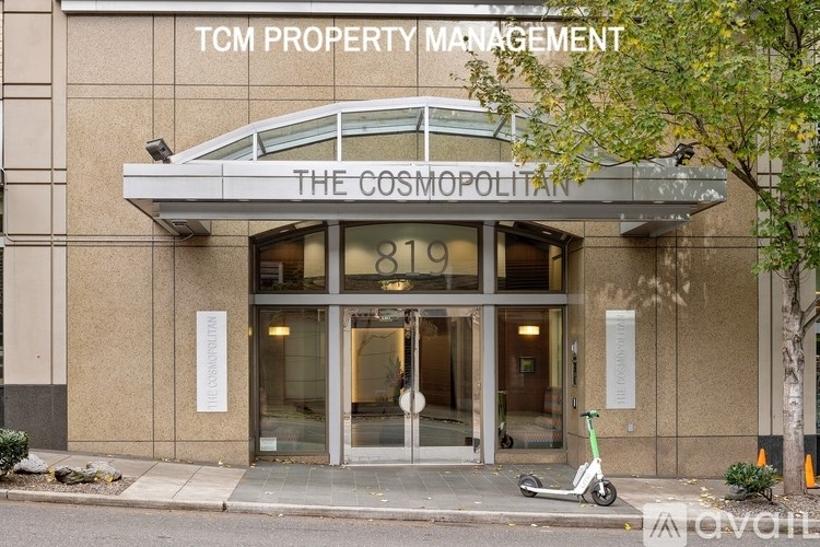 The front of a building with the sign "The Cosmopolitan" and the number 819 on it.