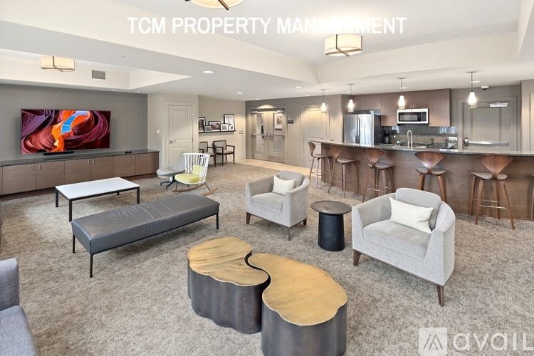 A living room with a grey sofa and a wooden coffee table.