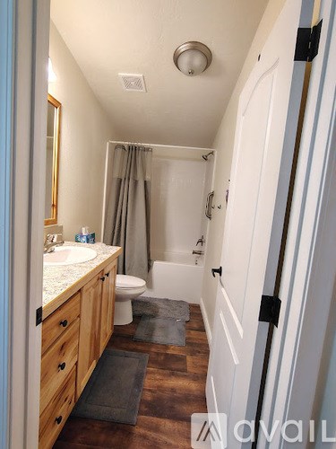 A bathroom with a sink, toilet, and bathtub.