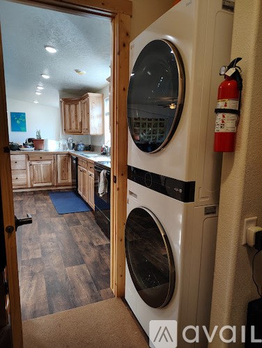 A washing machine is in a kitchen.