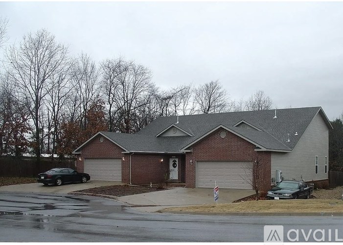 A house with a car parked in front of it.