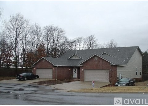 A house with a car parked in front of it.