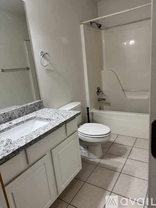 A bathroom with a toilet, sink, and shower.