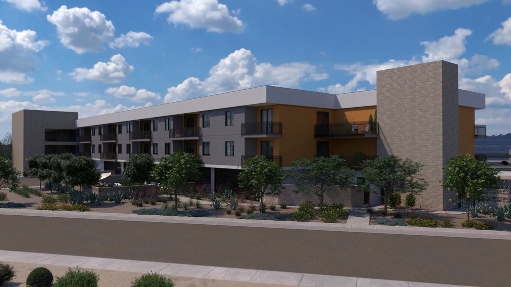 A modern apartment complex with a courtyard and trees.