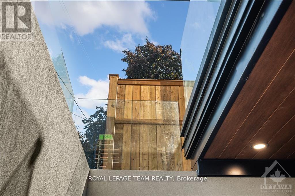A building with a tree in the background and a sign that says "Royal LePage Team Realty, Brokerage".