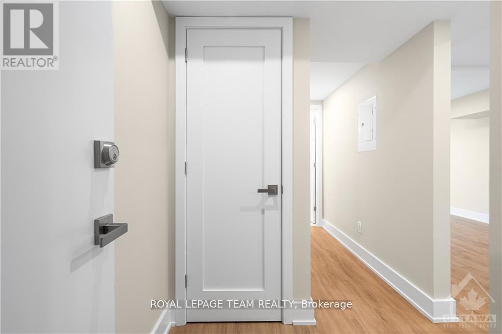 A white door with a black handle and a black lock.
