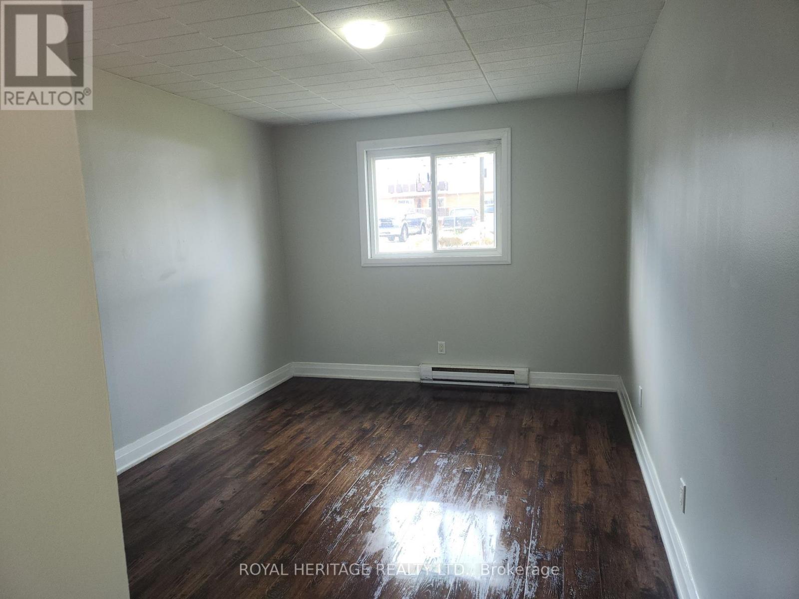 A room with wooden floors and a window.