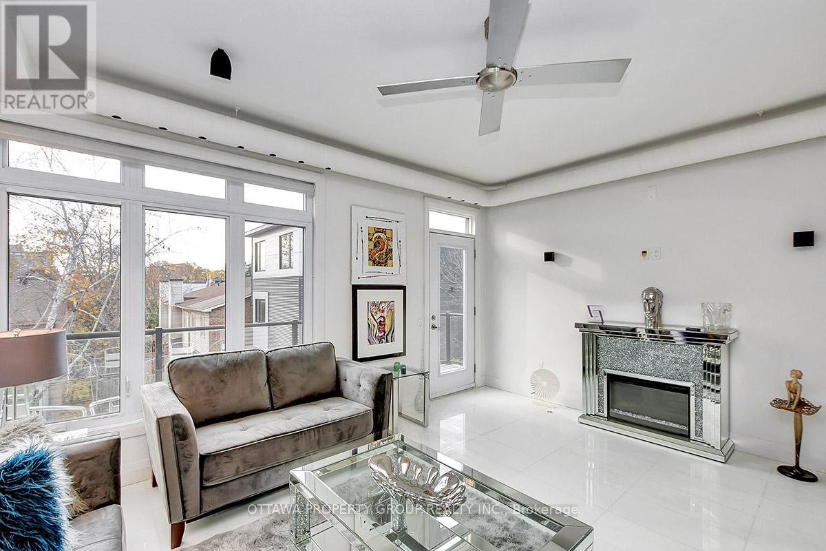 A living room with a grey couch and a glass coffee table.