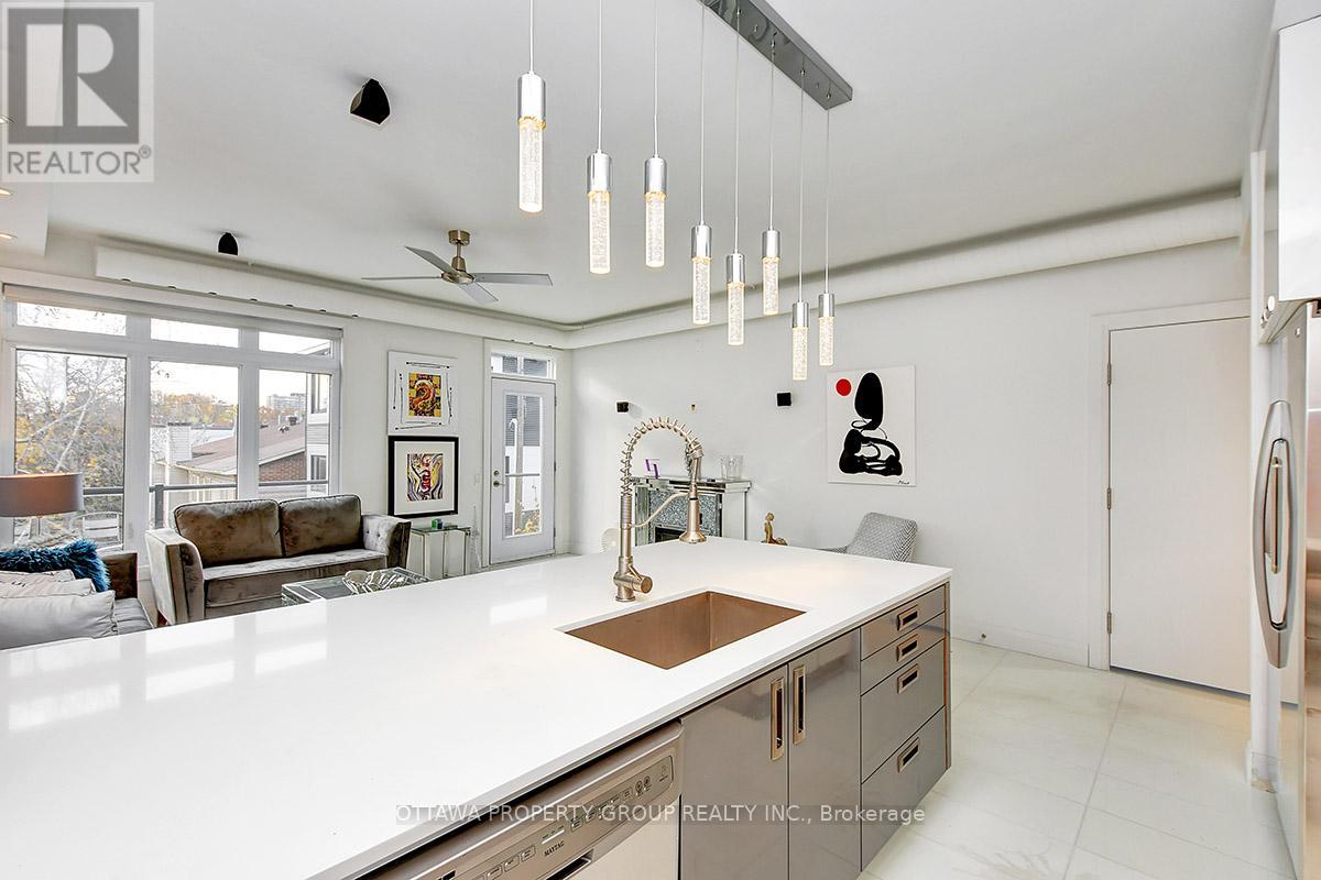 A modern kitchen with white cabinets and a large island.