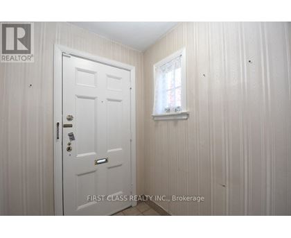 A white door with a window above it in a room.