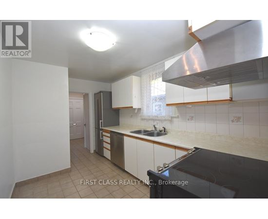 A kitchen with a sink and a stove top oven.