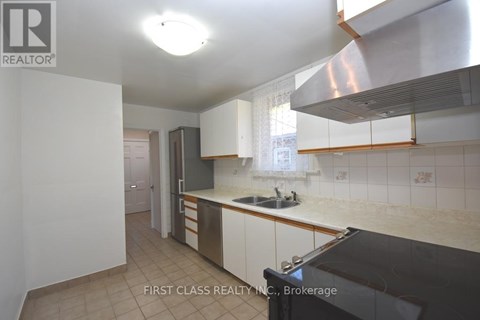 A kitchen with a sink and a stove top oven.