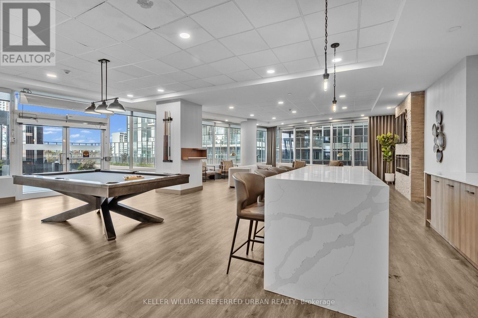 A spacious office with a pool table and a large marble table.