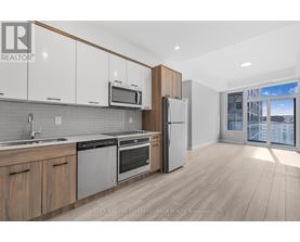 A modern kitchen with wooden cabinets and stainless steel appliances.