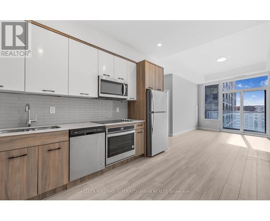 A modern kitchen with wooden cabinets and stainless steel appliances.