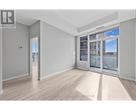 A spacious room with a view of the city through the windows.