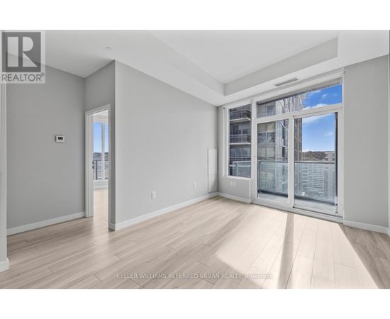 A spacious room with a view of the city through the windows.