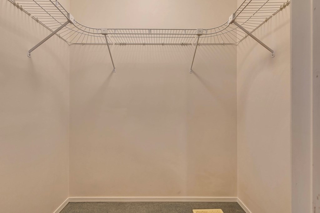 Empty wire shelving unit in a room.