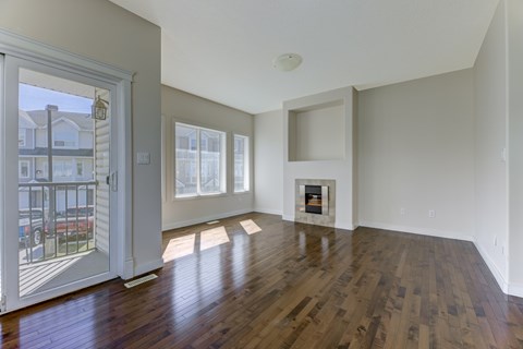 A room with a fireplace and a large window.