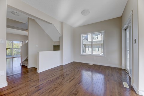 A room with wooden floors and a window.