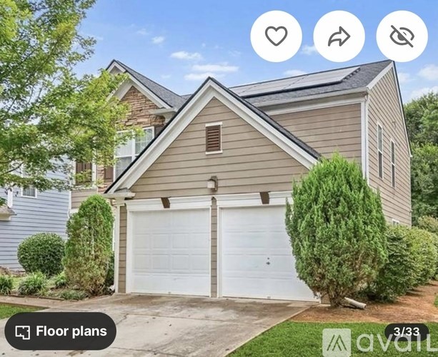 A house with a white garage door is for sale.