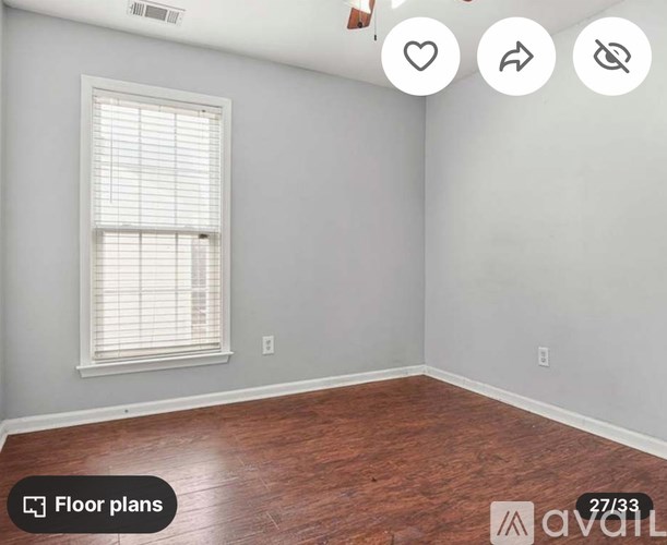 A room with a window and wooden flooring is available for rent.