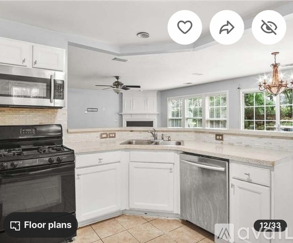 A kitchen with white cabinets and a black stove top oven.