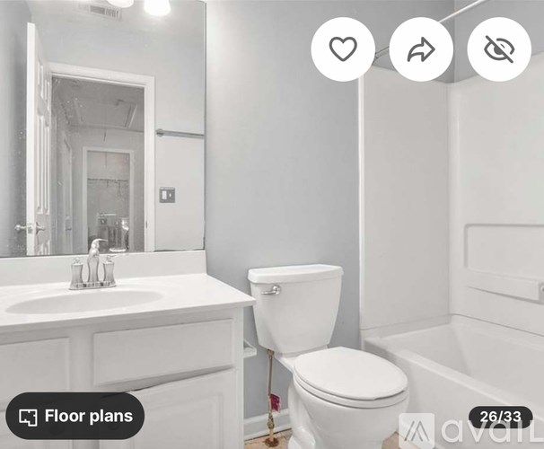 A white bathroom with a toilet, sink, and bathtub.