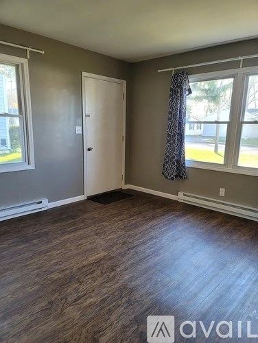 A room with a door, window, and Avail logo.