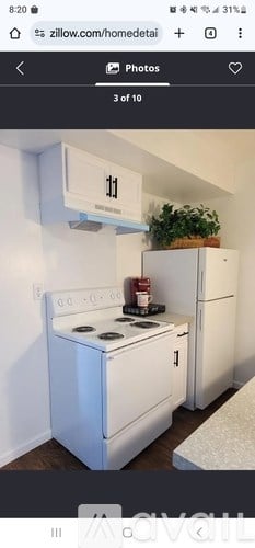 A white stove and refrigerator in a kitchen.