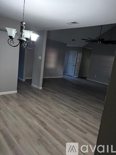 A room with a chandelier and a ceiling fan.