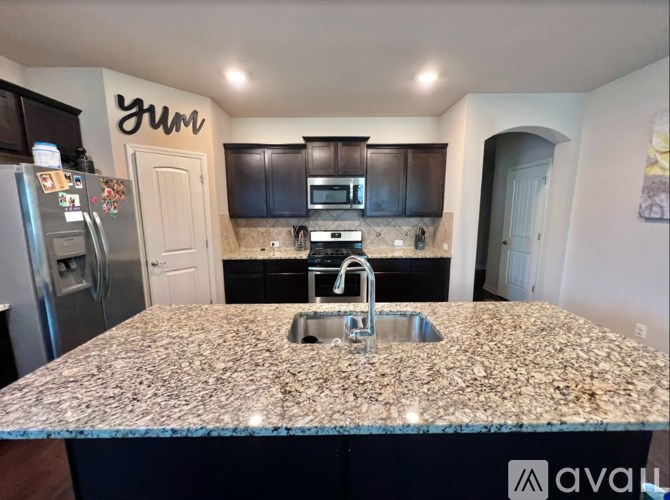 A kitchen with granite countertops and a sink.