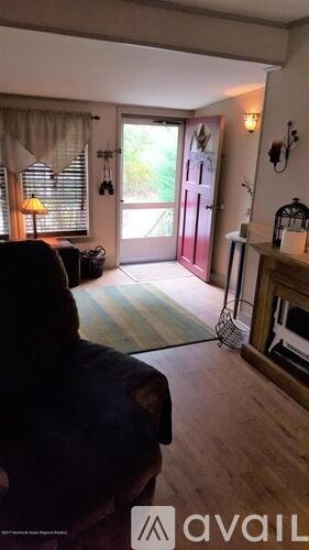 A living room with a sofa and a fireplace.
