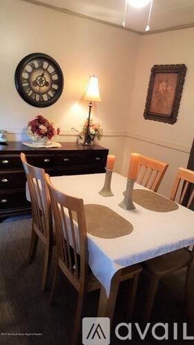 A dining room with a table set for four.