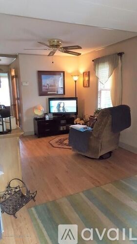 A living room with a television and a chair.