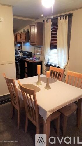 A kitchen with a table and chairs in front of a window.