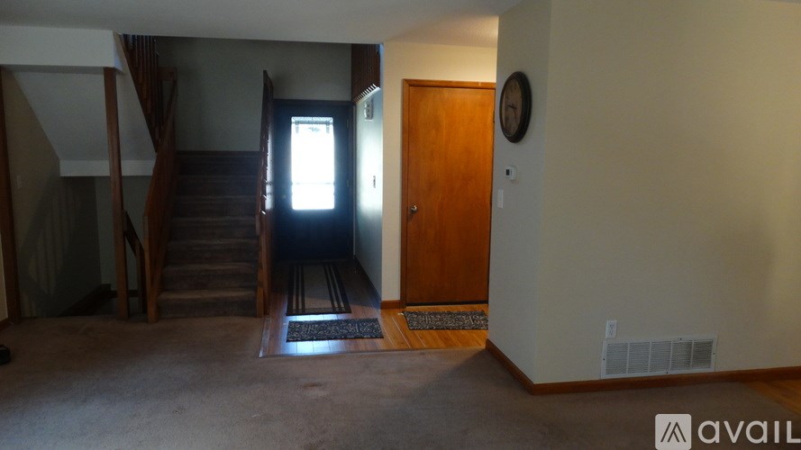 A room with a staircase and a door.