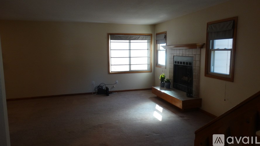A room with a fireplace and a window.