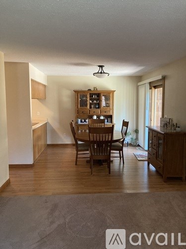 A dining room with a table and chairs is shown.