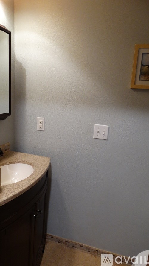 A bathroom with a sink and a mirror.