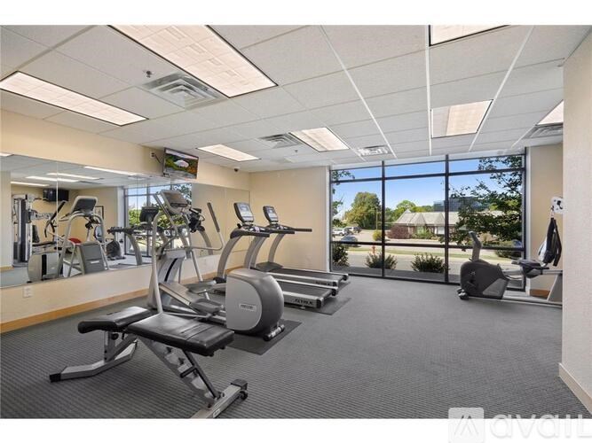 A gym with treadmills, elliptical machines, and other exercise equipment.