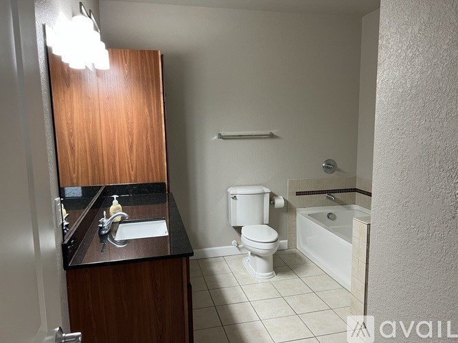 A bathroom with a toilet, sink, and bathtub.