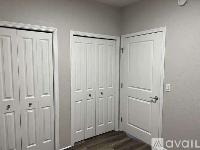 A hallway with four white doors.