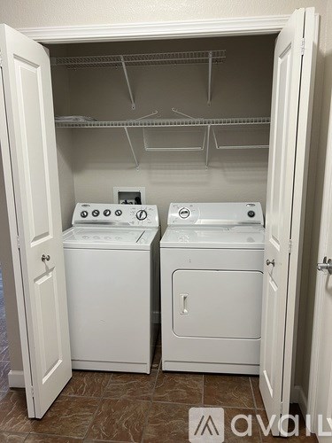 A small laundry room with a washer and dryer.
