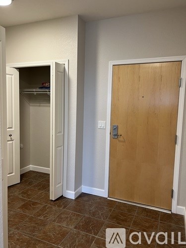 A room with a brown door and a white wall.