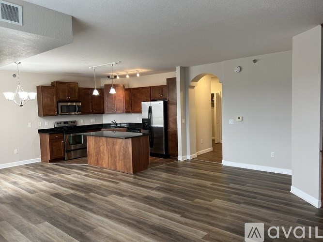 A kitchen with wooden cabinets and a countertop is available for rent.