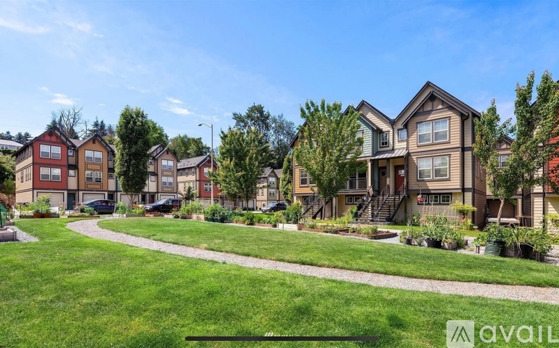 A row of houses with a grassy area in front.