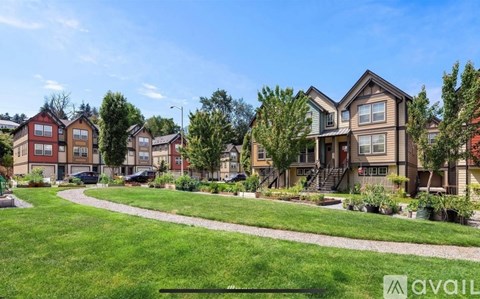 A row of houses with a grassy area in front.