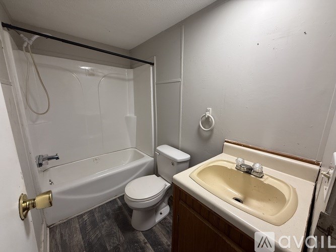 A bathroom with a toilet, sink, and bathtub.